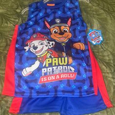 the paw patrol is on a roll shirt and shorts are laying on top of a bed