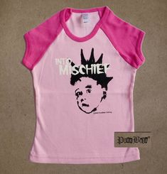 Into Mischief pink short sleeve tee with neon pink neck and raglan sleeves  -Inspired by The Misfits -Available in 2T or 4T -This style is fitted Our teensy styles are all hand printed on American made goods, in Los Angeles, with original Punk Baby® designs.   Shipping:  2-3 items (depending on size) will cost the same to ship within the US and internationally.  For international shipments, please allow more time to ship and to calculate shipping. Pink Punk T-shirt For Summer, Unisex Pink T-shirt With Band Merch, Unisex Pink Playful T-shirt, Pink Punk Style Summer Tops, Unisex Pink T-shirt For Spring, Pink T-shirt For Spring, Unisex Pink Summer Tops, Pink Unisex Tops For Spring, Pink Punk Style Summer T-shirt