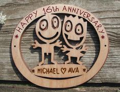 a wooden sign with two cartoon faces on it that says happy 16th anniversary michael ava