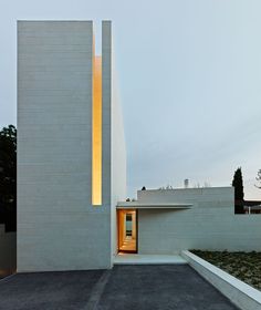 a white building with a yellow light on the side