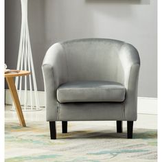 a gray chair sitting on top of a rug