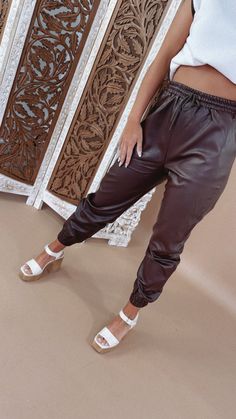 Upgrade your casual look with Leather Joggers. These stylish pants blend comfort with an edgy twist. Pair them with your favorite tops for a trendy outfit, whether you're running errands or hitting the town. Faux leather joggers Elastic cover waistband Elastic band ankle Pockets Fabric: 55% PU 45% VISCOSE MEASUREMENTS:S: 27 InchesM: 28 InchesL: 28.5 Inches Model Specs: Emily is wearing a size small in the photo.How will this item fit you? Check out our MODEL SPECS (Typical Sizing - Karli: S-Size Faux Leather Joggers, Leather Joggers, Vip Group, Stylish Pants, Everyday Chic, Trendy Outfit, Daily Activities, Chic Boutique, Long Hoodie