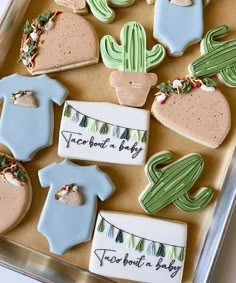 decorated cookies in the shape of cactus and baby ones