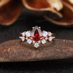 Unique garnet engagement ring set art deco red gemstone ring moonstone cluster wedding band round moissanite promise rings gifts for women RING DESCRIPTION ✦Engagement Ring ✴Center Stone - Garnet Shape - Pear Cut Size - 6*8mm ✴Side Stones - Moonstone Shape -Pear Cut Weight - About 0.28ct ✴Band Width - About 1.6mm ✦Wedding band ✴Stone - Moissanite & Moonstone Shape - Round Cut Weight - 0.246ct ✴Band Width - About 1.4mm ✴Ring Metal: Available in rose gold plated, yellow gold plated, 925 sterling s Elegant Jewelry With Lab-created Ruby For Promise, Elegant Lab-created Ruby Jewelry For Promise, Wedding Jewelry With Rose Cut Diamonds And Garnet, Garnet Jewelry With Rose Cut Diamonds For Promise Ring, Heirloom Lab-created Ruby Jewelry In Round Cut, Heirloom Style Jewelry With Lab-created Round Ruby, Heirloom Jewelry With Round Lab-created Ruby, Heirloom Style Lab-created Ruby Round Cut Jewelry, Elegant Red Stackable Jewelry