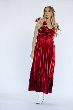 Indulge in luxury and make a statement this holiday season with our Cindy Velvet Dress in stunning red. Wrapped in soft velvet, this maxi dress exudes elegance and is adorned with a delicate bow detail. Dress to impress in this must-have piece for any special occasion. Product Materials: 95% Polyester, 5% Spandex Model Measurements: Hips 36” Waist 25” Bust: 31”, Height 5’5.5, wearing a size small