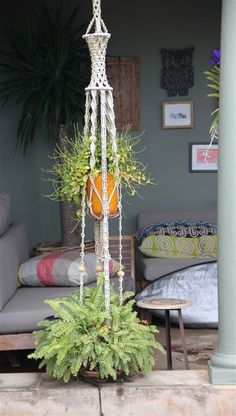 a living room with a couch and potted plants