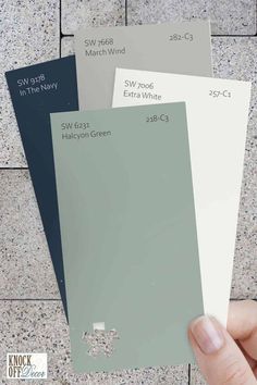 a hand holding three different colors of paint swatches on a tile floor with the words sw 568, sw 633 and white