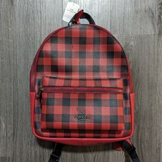 Coach Charlie Gingham Plaid Backpack Color: Black / Red Medium Backpack Coated Canvas And Leather Height 12.5" Width 10.75" Depth 4" Red Satchel Backpack For On-the-go, Coated Canvas School Backpack, Red Backpack With Removable Pouch For On-the-go, Casual Coach Bags For School, Coach Coated Canvas Backpack For On-the-go, Coach Backpack With Removable Pouch For School, School Backpack With Removable Pouch In Red, Coach School Backpack With Zipper Closure, Coach Backpack For Everyday Use