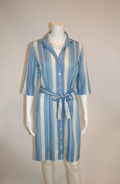 "Cotton shirtdress by John of California in stripes of blues, lavender, and off white.  Loose belt Mother of pearl buttons Size: no tag Measures laying flat: 18.5\" armpit to armpit, 18.5\" waist, 38\" shoulder to hem Condition: Good Vintage Condition" Spring Striped Belted Dress, Formal Summer Shirt Dress With Spread Collar, Striped Belted Dress For Spring, Striped Collared Shirt Dress With Button Closure, Long Sleeve Shirt Dress With Striped Collar For Summer, Knee-length Spring Dress With Vertical Stripes, Spring Knee-length Dress With Vertical Stripes, Elegant Daywear Dress With Striped Collar, Elegant Dresses With Striped Collar For Daywear