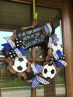 a wreath with a soccer ball on it hanging from the front door and saying, if we don't answer here at the soccer field