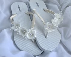 These beautiful flip flops are wrapped in ivory satin ribbon, and adorned with an ivory flowers. Ribbon color is ivory if you are needing other colors of ribbon or decoration please contact me and will be happy to accommodate you! All flip flops are handmade to order and the production time 1 to 2 weeks and then please allow additional time for shipping. Amazing for beach, weddings, flower girl or a fancy event, you choose! Please choose your size from the drop box. Adjustable Sandals For Spring Wedding, Summer Bridal Accessories For Bridal Shower, Summer White Bridal Accessories For Bridal Shower, White Summer Bridal Accessories For Bridal Shower, Cream Open Toe Sandals For Bridal Shower, White Sandals For Summer Ceremonies, White Bridal Accessories For Summer Bridal Shower, Pearl White Summer Wedding Shoes, White Summer Ceremony Sandals