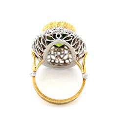 This is a truly beautiful ring, from the size and quality of peridot it features to the exquisite Florentine inspired craftsmanship. The large oval peridot is clear and crystalline, with bright, "Granny Smith" apple green color, set in 18k yellow gold to highlight its beauty. If August is your birth month, peridot is your birthstone. Sparkling round brilliant cut diamonds further adorn the white gold portion of the ring which has been intricately pierced, creating an elegant, regal appearance. H Luxury Peridot Rings With Accent Stones, Luxury Oval Peridot Rings, Oval Tsavorite Diamond Ring For Formal Occasions, Luxury Multi-stone Peridot Ring, Luxury Peridot Multi-stone Rings, Luxury Multi-stone Peridot Jewelry, Luxury Peridot Multi-stone Jewelry, Luxury Peridot Jewelry With Accent Stones, Formal Rings With Polished Peridot