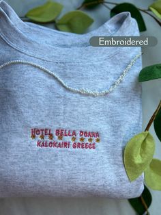 *Hotel Bella Donna Kalokairi Greece embroidered sweatshirt! This would make the perfect unique gift to treat yourself or a great gift for friends and family!  *This design is embroidered on the Ash colored crewneck shown in the product photos, but is available in other colors.  -Machine embroidered with high quality thread that gives this crewneck a vintage look! This sweatshirt will keep you warm and cozy as well as stylish!  ✰This item is MADE TO ORDER and can take 2-4 Weeks to be processed an Multicolor Embroidered Text Crew Neck Sweatshirt, Embroidered Relax Fit Sweatshirt For Gift, Embroidered Relaxed Fit Sweatshirt As Gift, Embroidered Relaxed Fit Sweatshirt For Gift, Multicolor Embroidered Logo Sweatshirt Crew Neck, Long Sleeve T-shirt With Machine Embroidery As Gift, Custom Embroidered Long Sleeve T-shirt, Embroidered Logo Crew Neck Sweatshirt, Long Sleeve T-shirt With Embroidered Logo As Gift