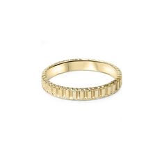 a yellow gold ring with small squares on the inside and outside, set against a white background