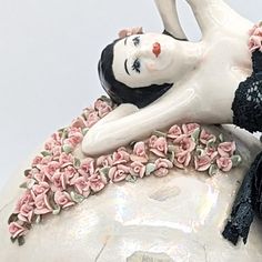 there is a ceramic figurine that looks like a woman laying on her back