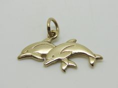 This beautiful charm is an authentic James Avery piece in yellow gold stamped with the candle sticks 14K ©. The charm is called Twin Dolphins and it is a retired piece and a very rare find. The charm measures 1" in length and the jump ring is cut. The charm does not come in its original packaging. RING SIZE: N/A TOTAL WEIGHT: 2.3 Grams CONDITION: Excellent REF. CODE: LB3416 Feel free to Visit My ebay Store and browse through my other items for some more unique fine jewelry and collectibles. All Gold Pendant Charm With Polished Finish, Gold Polished Pendant Charm, Yellow Gold Engraved Pendant Charms, Symbolic Yellow Gold Charms For Gift, Yellow Gold Pendant Charms For Anniversary, Classic Engraved Yellow Gold Charms, Symbolic Engraved Yellow Gold Charms, Classic Sterling Silver Charms, Classic Gold Sterling Silver Charms