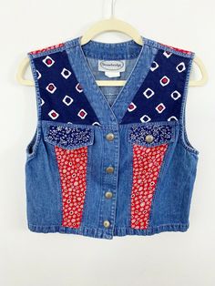 Stonebridge Denim Sleeveless Vest Size Medium Red Floral Blue Geometric Country Very good preowned condition - MISSING A BUTTON ON ONE OF THE FAUX POCKETS No holes or stains Measurements lying flat: pit to pit 18", length 17" Prairie, Country, Ranch, Western Smoke and pet free home Blue Patchwork Sleeveless Vest, Blue Sleeveless Patchwork Vest, Sleeveless Patchwork Denim Vest, Retro Sleeveless Denim Vest For Summer, Blue Cotton Retro Denim Vest, Blue Retro Cotton Denim Vest, Retro Blue Cotton Denim Vest, Sleeveless Denim Vest For Festivals, Red Vintage Vest For Summer