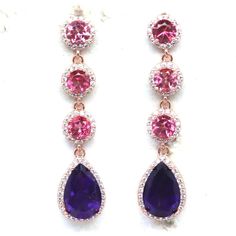 **Beautiful earrings - 8 x 12 MM. Purple Amethyst, Topaz & Cubic Zirconia Earrings 925 Sterling Silver **18k Rose Gold plate on Sterling Silver Huggie Style, Very secure back hoop that protects your earrings. You will wear this jewelry in style on any occasion or daily wear.  **Main stone - Amethyst ** Main Stone Color- Purple ** Style - Dangle/Drop ** Jewelry Dimension- 10.4 x 44.0 mm ** Gem Dimension- 8.2 x 12.1 - 1.2 mm. ** Total Carat Weight-  32.05 ct ** Main Stone Creation- Natural ** Main Stone Treatment -Unheated ** Secondary Stone- Topaz, Cubic Zirconia ** Base Metal- 925 parts per 1000 Sterling Silver ** Cut Grade- Excellent ** Luster - Charming ** Main Stone Shape - Pear ** Stone Origin - Thailand Pink Stone Earrings For Gift, Pink Stone Earrings Gift, Pink Gemstone Earrings For Wedding, Pink Gemstone Accented Earrings For Weddings, Pink Gemstone Wedding Earrings, Pink Wedding Earrings With Gemstone Accents, Dangle Earrings With Gemstone Accents In Cubic Zirconia, Pink Sparkling Stone Round Earrings, Pink Gemstone Accented Party Earrings