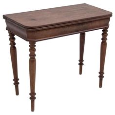 an old wooden table with turned legs and a drawer on the top, isolated against a white background