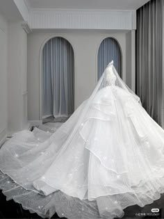 a white wedding dress on display in a room