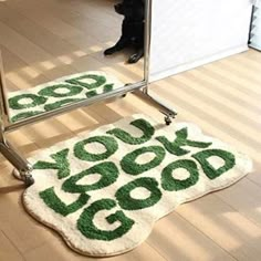 a dog sitting on the floor in front of a mirror