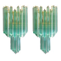 a pair of green glass wall sconces with brass fittings on each end