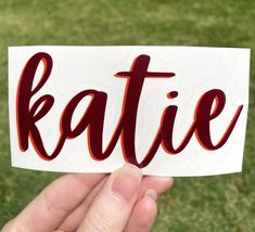 someone is holding up a sticker with the word rattie written in red on it