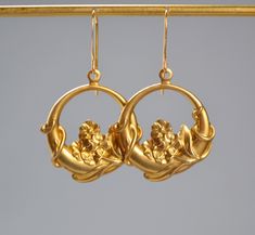 "Unique pair of Art Nouveau style earrings. The pendant is made of solid brass. The earwires are 14k gold plated, hypoallergenic and nickle free. The overall length of the earring is 1.75\" and the width is just over 1\". Earrings are lightweight. Your earrings will be shipped in a small gift box. Over time brass may tarnish so I will included a polishing cloth with your purchase. All earrings in my shop ship free in the US. If you are unhappy or have an issue with your jewelry please contact me and I will make it right.  Thank you for shopping in my store and feel free to reach out if you have any questions." Art Nouveau Gold Pierced Earrings, Gold Art Nouveau Pierced Earrings, Art Nouveau Gold Wedding Earrings, Art Nouveau Gold Earrings For Wedding, Nickel-free Gold Art Nouveau Jewelry, Gold Art Nouveau Earrings For Weddings, Gold Nickel-free Art Nouveau Jewelry, Yellow Gold Brass Flower Earrings For Pierced Ears, Yellow Gold Flower Earrings In Brass