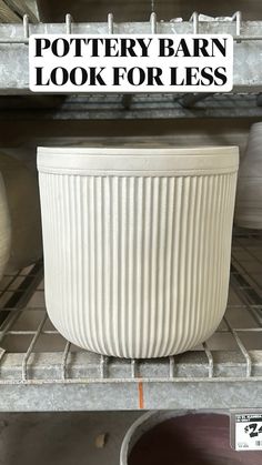 a white pot sitting on top of a metal shelf next to a bowl with the words pottery barn look for less