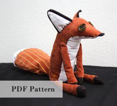 a stuffed fox sitting on top of a table