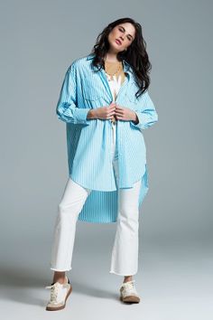 Introducing our Light Blue Oversized Blouse with White Stripes, a chic and versatile addition to your wardrobe. This maxi blouse in a refreshing light blue hue adorned with crisp white stripes exudes laid-back elegance, making it the perfect choice for various occasions.  Designed with an oversized fit, this blouse offers a relaxed and comfortable silhouette, ideal for layering over a bathing suit or pairing with a white skirt for a stylish ensemble. The polo collar and long sleeves add a touch of sophistication to the overall look, while the metallic finish on the poplin fabric brings a subtle shimmer to your outfit.  Featuring chest pockets and a button placket, this blouse combines fashion with functionality. Crafted from 100% polyester, it ensures durability and easy care for your conv Oversize Blouse, Tan Scarf, Stripe Blouse, Oversized Blouse, White Skirt, Polo Collar, Casual Elegance, Striped Blouse, Basic Style