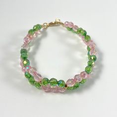 Dressy pink and green twisted faceted glass bead bracelet, round gold accents and gold lobster clasp Adjustable Pink Faceted Crystal Bracelet, Pink Faceted Beaded Bracelets, Pink Czech Glass Bracelets With Faceted Beads, Beaded Bracelets Pink, Bracelets Pink, Twist Bracelet, Glass Bead Bracelet, Twisted Bracelet, Memorial Bracelet