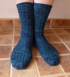 the legs and ankles of a person wearing blue socks with black plaid pattern on them