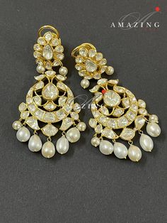 Silver Moissanite Polki Earring, Kundan Chandelier Bridal Jewelery, Traditional Jewelery 925 Silver Earring,18K Plated, Wedding Jewelery Statement Earring Drop Pearl Earring Material : Silver Gemstone: Moissanite, Drop Pearl Stone colour: Uncut Polki Primary colour: Gold Size-Length60mm Width:30mm Closure : Screw back and Clips Silver Intricate, hand crafted, Pure Silver Polki Earrings, studded with high quality Moissanite Polki comes with screw back and clips, made in 92.5 silver with 22ct gold Polki Gold Earrings, Luxury Rose Cut Diamond Chandelier Earrings For Wedding, Diamond Chandelier Earrings In Yellow Gold For Wedding, Yellow Gold Diamond Chandelier Earrings For Wedding, Wedding Chandelier Earrings In Yellow Gold With Diamonds, Wedding Yellow Gold Diamond Chandelier Earrings, Hallmarked Dangle Bridal Earrings, Hallmarked Dangle Bridal Earrings For Wedding, Luxury Hallmarked Chandelier Earrings For Wedding