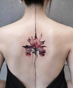 the back of a woman's neck with flowers painted on it