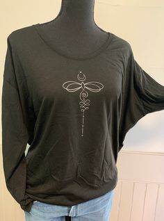 "Vintage BOHO Dragonfly unalome tattoo art black scoop neck long sleeve cute shirt Graphic tee inspirational shirt for women, lightweight Ranae's size recommendation...true to size; order your regular size! Designed and screen printed in our USA shop Fabric: * 65% polyester, 35% rayon, Feature: * High stitch density for smoother printing surface * Tearaway label * Self-fabric sleeve cuff * Loose-fit silhouette with side seam and tapered bottom * Single-needle scoop neck with 1/2\" rib collar * S Black Bohemian T-shirt With Relaxed Fit, Black Bohemian Relaxed Fit T-shirt, Black Screen Print Top With Comfortable Fit, Comfortable Black Top With Screen Print, Black Bohemian Crew Neck Top, Unalome Tattoo, Scoop Neck Long Sleeve, Cute Shirt, Sleeve Cuff