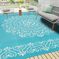 a blue area rug with white designs on it and two chairs sitting in front of the rug