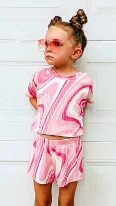 This beautiful groovy pink swirl outfit is sold as a set. Comes with a short sleeved  crop top and a pair of breezy shorts. Made with soft and stretchy yummy rib knit fabric that is so comfy for your girl to wear all summer long!  ➡️If you would like a custom length tee and not a cropped tee, please choose "Custom Size" and in the notes section at checkout, please provide me with the length of the tee that you want from the center back neck down to the hem.  Sizes are: XSmall (6-12mo) Small (12- Spring Matching Set Tops For Playwear, Spring Playwear Short Set, Spring Short Set For Playwear, Playful Short Tops For Spring, Spring Playwear Short-sleeved Tops, Multicolor Short Sleeve Short Set For Spring, Pink Cotton Short Set For Beach, Pink Short Set For Summer Loungewear, Pink Summer Loungewear Short Set