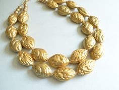 A unique beaded statement necklace made with gold acrylic shell shaped beads. The beads are lightweight. - Shortest strand is 18-20" long- Bead size is 1.25" x .75"- Gold stainless steel lobster claw clasp (gold filled is also available)- 2" gold plated stainless steel extender chain- Lead free pewter multi strand connector The mannequin's neck size is 14.5". We can make this necklace longer or shorter.All DLD jewelry comes in a silver jewelry box for gift giving. We use the highest quality find Branch Earrings, Lucite Jewelry, Silver Jewelry Box, Chunky Statement Necklace, Necklace Chunky, White Agate, Beaded Statement Necklace, Teardrop Pendant, Chunky Necklace