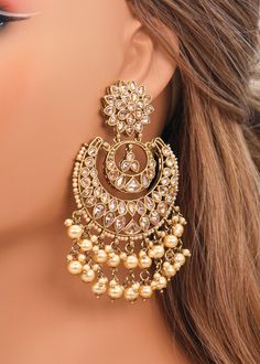 These Polki earrings are a classic addition to any traditional outfit with their stunning stones, crystals, and pearls. They add an exquisite charm and make for the perfect accessory to complete your look. Earrings length: Approx. 3.5" Weight of each earring: 31 gms Push-Back Closure. Antique Gold Plated on high-quality brass as the base metal In-stock & ready-to-ship Color may vary slightly due to light condition & photography. Jewelry Care: Keep away from moisture. Allow perfumes and lotion to Earrings With Lehenga, Gold Crystal Earrings, Onam Earrings, Earing Designs Gold For Wedding, Chandbali Earrings Gold Antiques, Jhumka Earrings Aesthetic, Golden Earrings Indian, Big Earrings Indian, Kashmir Outfits