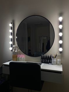 a mirror that is sitting on top of a desk next to a table with some bottles