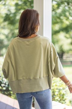 Mineral washed olive green french terry knit pullover top with hi-low bottom hem Sass up your casual attire with our Sunset Ready Washed Olive Top! This fun, comfy top features french terry knit fabric, wide 3/4 length sleeves, and a split hi-low bottom hem. Perfect for adding a quirky twist to any casual day out! Relaxed fit; semi-cropped Model is 5'5" wearing a small Fabric contains stretch Ribbed distressed crew neckline Wide 3/4 length sleeves with drop shoulder Front side slits and distress Oversized French Terry Tops For Layering, French Terry Tops For Everyday Spring Wear, Trendy Soft-washed French Terry Tops, Casual French Terry Tops For Layering, Oversized French Terry Top For Spring, Soft-washed French Terry Tops For Spring, Oversized Cropped Top For Loungewear, Casual French Terry Top With Drop Shoulder, Casual French Terry Drop Shoulder Tops