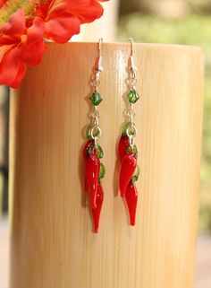 "Chili pepper lovers, these funky earrings are a must for you I created these sassy, red earrings are handcrafted of red and green glass lamp work beads that suspend from a Swarovski crystal. These cute earrings make the perfect unique gift! You can customize these food earrings to suit your personal style and budget with your choice of sterling silver, 14k gold filled, gold plated, or silver-plated material. D E T A I L S * Earring Length: 2\" (not including ear wire) * Metal Choices: 100% 14k Fun Nickel Free Drop Earrings, Fun Drop Earrings With Ear Wire, Handmade Red Plug Earrings As Gift, Nickel Free Novelty Earrings For Party, Fun Nickel-free Drop Earrings, Fun Nickel-free Dangle Earrings, Handmade Fun Red Earrings, Fun Dangle Earrings With Ear Wire, Unique Red Earrings For Party