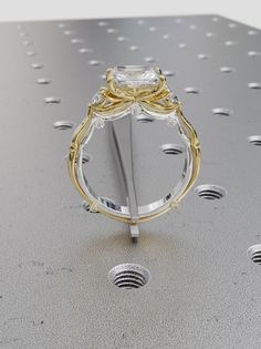 a diamond ring is shown on top of a metal surface