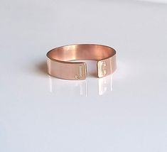 "Dainty and beautiful, this open 14 kt rose gold-filled personalized initial ring is great by itself or stacked. On each end you can have your first and last initials engraved, or simply the first initial of you and your loved one!! Approximately 4mm wide. Please don't forget to leave a message in the \"note to seller\" field upon checkout letting me know the two initials that you would like to have stamped. The font I use is upper case Arial. If you would like your initials to be in lower case Stackable Rose Gold Initial Ring Open Design, Stackable Rose Gold Initial Open Ring, Stackable Open Initial Ring In Rose Gold, Rose Gold Initials Promise Ring, Rose Gold Promise Ring With Initials, Engraved Initials Promise Ring In Rose Gold, Rose Gold Open Band Midi Rings As Gift, Rose Gold Open Ring With Initial For Anniversary, Rose Gold Initials Open Ring Jewelry