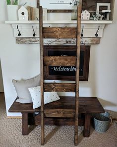 a wooden ladder sitting on top of a table next to a wall mounted shelf filled with books