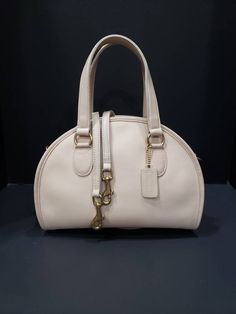 "For your consideration is this beautiful vintage Coach Chadwick Bag, or Bowler (style #9928) in Bone or ivory-white, with brass hardware. It is a \"Leatherware Era\" bag, and was made in the United Sates before 1994. It is in near Mint restored condition. I consider this bag to be the Grail of vintage Coach purses, and is one of the most beautiful bags that Coach made during this era. It is my favorite, and especially rare in bone. The Chadwick satchel is a unique Coach style that is sought aft Vintage White Top Handle Shoulder Bag, Classic Cream Satchel For Formal Occasions, Vintage White Bag With Detachable Handle, Vintage Cream Shoulder Bag With Detachable Strap, Vintage Cream Bags With Detachable Handle, Vintage Cream Shoulder Bag With Detachable Handle, Vintage White Bags With Gold-tone Hardware, Vintage Leather Satchel In Cream, Classic Cream Satchel For Evening