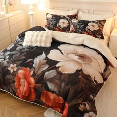 a bed with black and white flowers on it