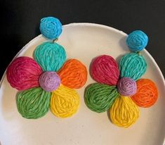 With a distinct 60's flower child vibe, these fun and brightly hued earrings are raffia over brass and sway nicely when you move your head.  Mint, hot pink, neon orange, bright yellow, sage and turquoise colors.  Lightweight, post back.  A 2 ¾" dangle length. 28-116 Spring Multicolor Flower Earrings, Multicolor Flower Earrings For Summer Beach, Spring Rainbow Earrings, Playful Multicolor Handmade Flower Earrings, Playful Handmade Multicolor Flower Earrings, Flower-shaped Earrings For Spring Vacation, Spring Beach Earrings In Flower Shape, Flower-shaped Earrings For Vacation In Spring, Multicolor Flower Earrings For Beach