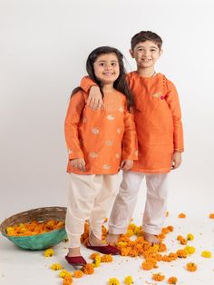 Siblings Set - Orange Embroidered Chanderi Kurta Sets (Set 2) By Mr Brat now available at Trendroots Orange Cotton Sets With Pallu, Festive Orange Sets With Chikankari Embroidery, Orange Dabka Sets For Festivals, Orange Cotton Kurta With Dabka, Orange Cotton Kurta With Pallu, Orange Chikankari Embroidered Sets For Festivals, Festive Orange Embroidered Kurta, Festive Embroidered Orange Kurta, Orange Long Sleeve Traditional Wear For Navratri